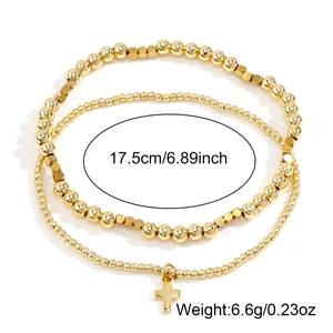 Gold layered beaded bracelet set with cross pendant and sizing details on white background