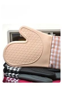 Close-up of heat-resistant orange silicone oven mitt with non-slip diamond texture and plaid cuff
