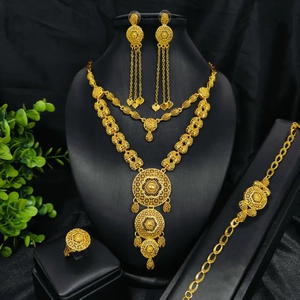 Close-up of 24k gold plated jewelry set with intricate hollow disc patterns and tassels