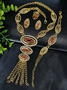 Detail of 24k gold plated jewelry set with red zircon stones and elegant long tassels