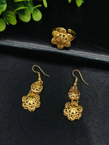 Close-up of ornate 24k gold plated floral filigree earrings and adjustable open ring