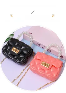 Detail of mini jelly bags with quilted pattern, pearl handles and gold chain straps