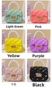 Close-up of mini quilted jelly bags with pearl handles and gold chain straps