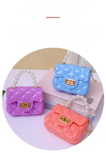 Detail of colorful jelly handbags with diamond lattice pattern and pearl handles