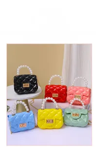 Detail of mini quilted jelly bags in multiple colors with pearl handles and chains