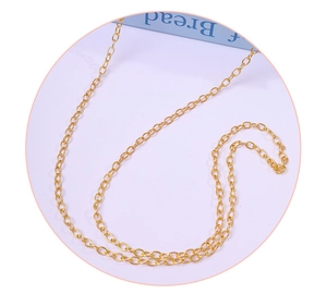 Close-up of elegant gold cable chain necklace with polished links on soft background