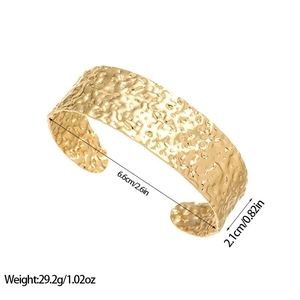 Detailed view of wide hammered gold bangle with size 6.6cm and weight 29.2g specifications
