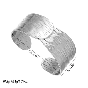 Detailed view of silver wide cuff bracelet featuring irregular hammered metal texture