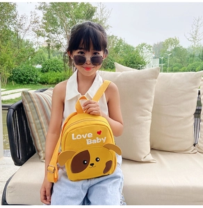 Detailed view of yellow canvas toddler backpack with cute dog ears and adjustable straps