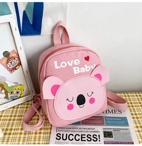 Detailed close-up of pink canvas toddler backpack featuring a cute koala face design