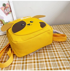Detail shot of a yellow cartoon dog backpack made of soft canvas for toddlers