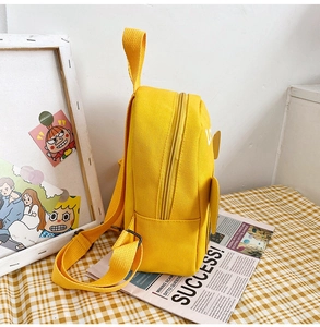 Close-up of yellow canvas kids backpack with Love print and adjustable straps