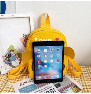 Detail view of yellow canvas toddler backpack with Love print and cute ear decorations