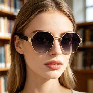 Detail of octagonal gold metal frame sunglasses with gradient purple lenses for women