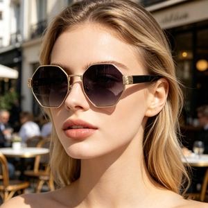 Close-up of trendy hexagonal gold metal sunglasses with gradient lenses on a female model