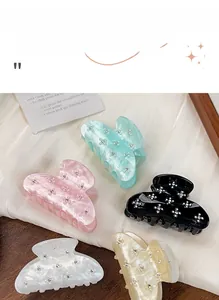Detailed macro view of acrylic flower hair claw clips with delicate rhinestones