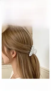 Elegant acrylic flower hair claw clip with pearls and rhinestones on model's hair