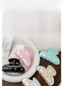 Elegant acrylic hair claw clip with floral rhinestone details for versatile styling