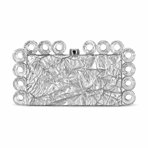 Close-up of silver metallic evening clutch with crushed texture and ring trim detailing