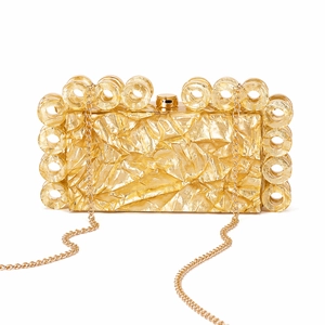 Detail of gold evening clutch featuring crinkled texture and decorative hollow rings