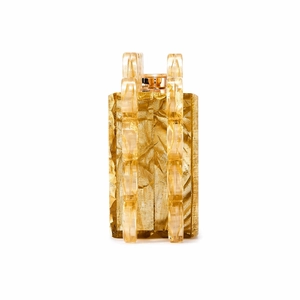 Close-up of gold evening clutch with hammered metal texture and amber acrylic ring handles