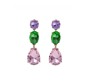 Close-up of triple-layered teardrop crystal earrings with purple, green and pink gems