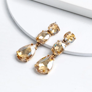 Detail of champagne crystal drop earrings with teardrop, oval, and round cut stones