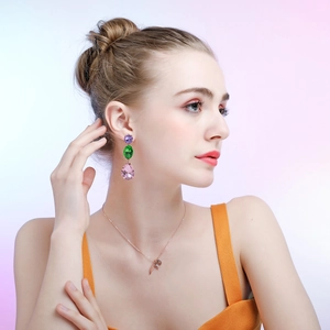 Close-up of elegant tear-drop crystal earrings and necklace set on female model
