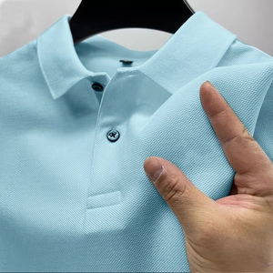 Detail of sky blue pique polo shirt fabric showing breathable texture and soft material