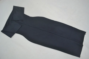 Detailed flat lay of a black off-shoulder cocktail dress with slim fit tailoring