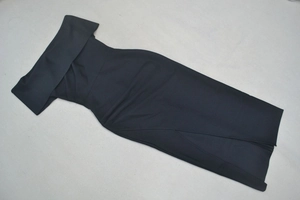 Detailed flat lay of black off-shoulder midi dress featuring side slit and elegant bardot neckline