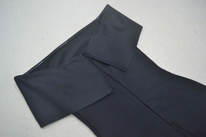 Detail of off-shoulder neckline and invisible zipper on black bodycon evening dress