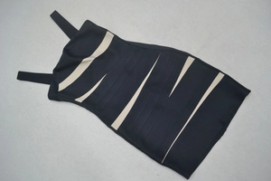 Détail de la texture bandage à rayures beiges et noires sur une mini robe moulante