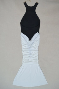 Detail of black and white halter dress with gold metal buckle and pleated waist texture