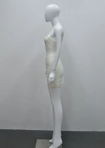 Gros plan d'une mini-robe bandage blanche de profil montrant la texture côtelée ajustée