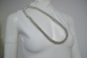 Close-up of the elegant silver rhinestone straps on the shoulder of the evening dress
