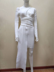 Detail of white bodycon bandage dress with asymmetrical cutout and draped skirt panel