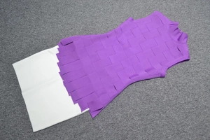 Detail of purple sleeveless high neck top with layered woven bands and white hemline