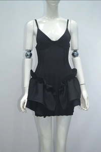 Detail of black bodycon mini dress featuring ruffled tiers and structured cup design
