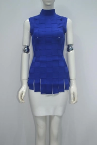 Detail of royal blue turtleneck knit vest featuring woven texture and fringe hem detail
