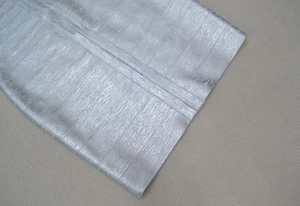 Macro view of silver metallic bandage fabric showing detailed texture and stitching