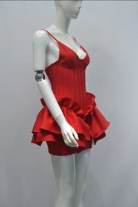 Detail view of the red corset-style mini dress with multi-layered ruffle hem and slim straps