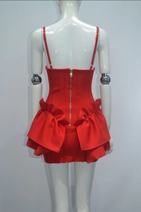 Detailed back view of red bodycon dress featuring gold zipper and tiered ruffle accents