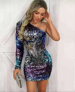 Detail of shimmering multi-color sequin fabric on one-shoulder slim fit party dress