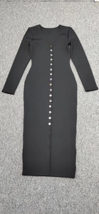 Detail of black ribbed knit dress featuring vertical multi-button V-neckline
