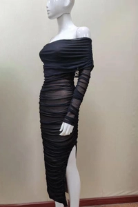 Detail view of ruched black mesh fabric texture and elegant side slit on long formal dress