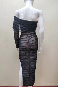 Detail view of the asymmetric ruched evening dress with a high side slit design