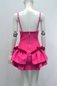Back view of a rose red bandage mini dress featuring a gold zipper and ruffled hem