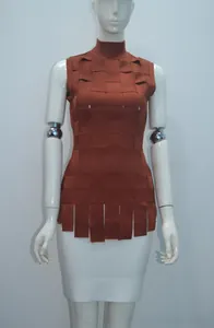 Macro shot of orange latticed knit sleeveless top with high neck and fringe details