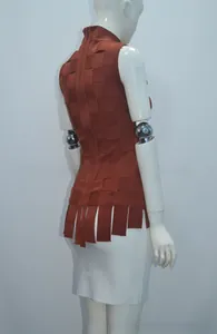 Detail of rust red sleeveless top with textured grid weave and fringe hem close-up